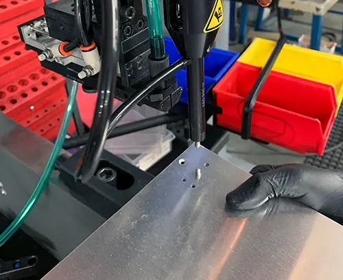 Panel is accurately located on the machine and the insert is automatically fed into position.